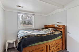 Bedroom with carpet flooring and lofted ceiling with beams