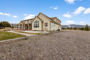 Exterior space with a mountain view, cooling unit, covered porch, and a garage