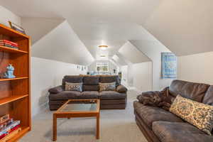 Living room featuring light carpet and lofted ceiling