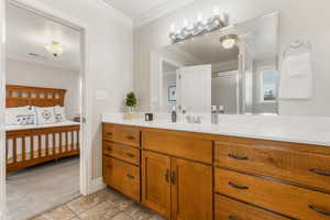 Bathroom with vanity, tile patterned floors, walk in shower, and crown molding