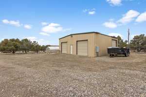 View of outbuilding featuring a garage