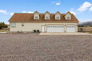 View of front of home featuring a mountain view and central AC unit