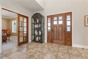 Tiled foyer with ornamental molding