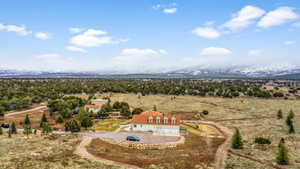 Drone / aerial view with a mountain view and a rural view