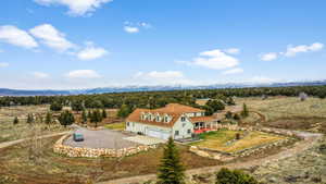 Birds eye view of property featuring a mountain view and a rural view