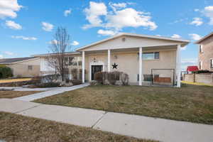 View of front of house with a front yard