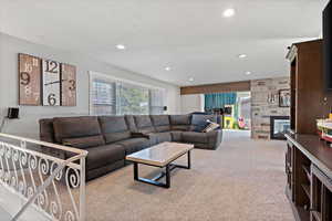 Carpeted living room featuring a fireplace