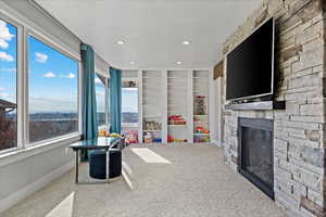 Rec room with a stone fireplace