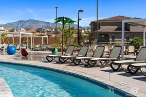 View of pool with a mountain view and a patio area