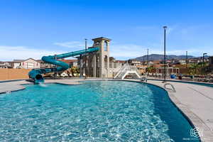 View of swimming pool with a mountain view and a water slide