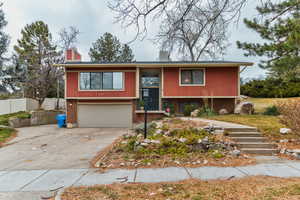 Split foyer home featuring a garage