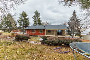 Rear view of house with a trampoline