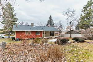 Rear view of property with central AC and a sunroom