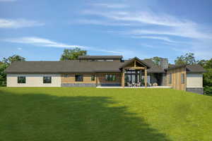 Rear view of house featuring a lawn and a patio area