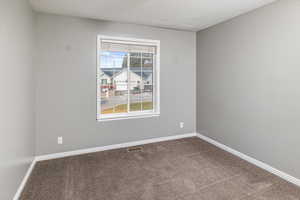 Unfurnished room with carpet floors