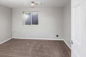 Carpeted spare room with a textured ceiling