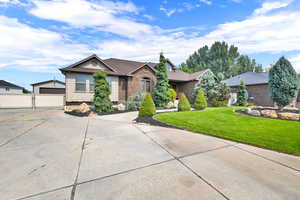 View of front of house featuring an outbuilding, a front yard, and a garage