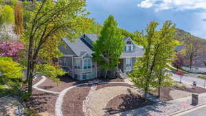 View of front of property with roof with shingles and stairway