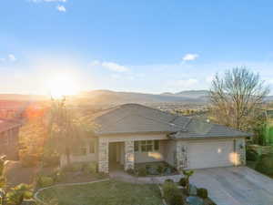 View of front of home featuring a mountain view and a garage