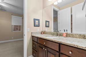 Bathroom featuring ceiling fan and vanity