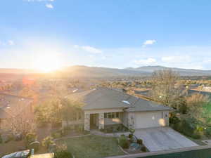 View of front of home with a mountain view, a garage, and a front yard