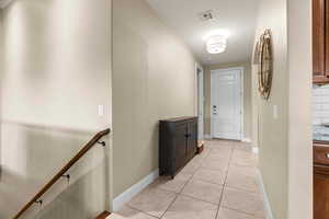 Hallway featuring light tile patterned floors