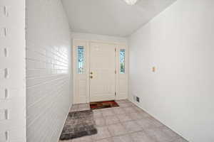 Entrance foyer with light tile patterned flooring