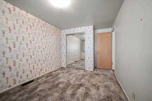 Interior space with carpet flooring and a closet