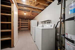 Washroom with water heater and washing machine and clothes dryer