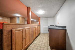 Kitchen featuring sink and a textured ceiling