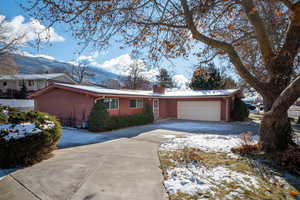 Single story home featuring a mountain view and a garage