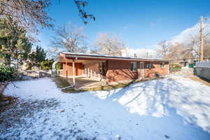 Snow covered house with a patio area