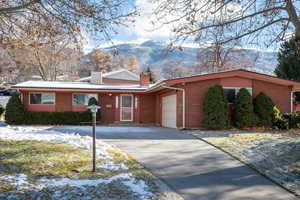 Ranch-style home featuring a mountain view and a garage