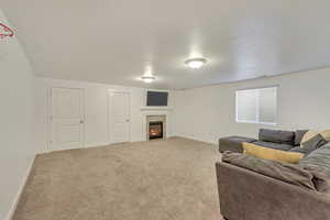 Living room with light carpet and a tile fireplace