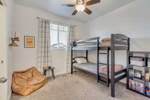 Bedroom featuring ceiling fan and carpet floors