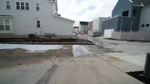 View of home's exterior featuring cooling unit and a garage