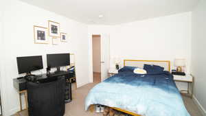 Bedroom featuring light colored carpet