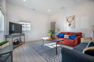 Living room with light hardwood / wood-style flooring