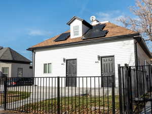 View of front of house featuring solar panels