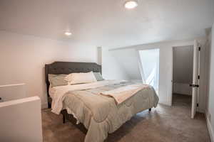 Bedroom featuring carpet and a textured ceiling