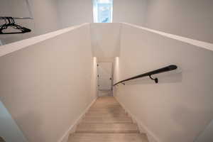 Stairway with hardwood / wood-style floors