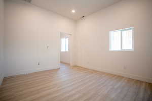 Empty room with light hardwood / wood-style flooring