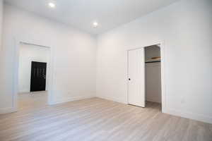 Unfurnished bedroom featuring a closet and light hardwood / wood-style flooring