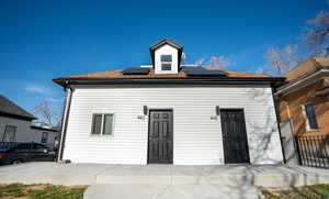 View of front of home featuring solar panels