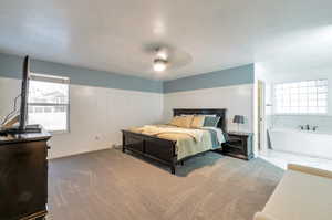 Carpeted bedroom featuring ceiling fan