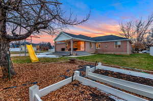 View of front of property featuring a playground and a yard