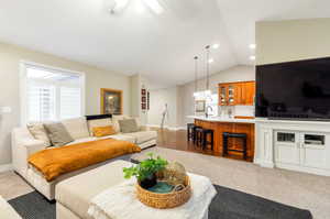 Living room with lofted ceiling and sink