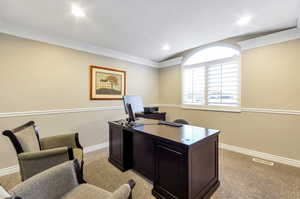 Carpeted office featuring ornamental molding