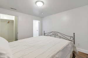 Bedroom featuring a closet and wood-type flooring