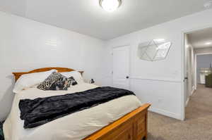 Carpeted bedroom featuring a textured ceiling